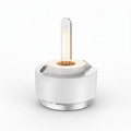 HOPEN Salt Water Lamp with exposed Edison-style filament bulb, white cylindrical base with chrome accents, glowing warm amber light, isolated on white background. 